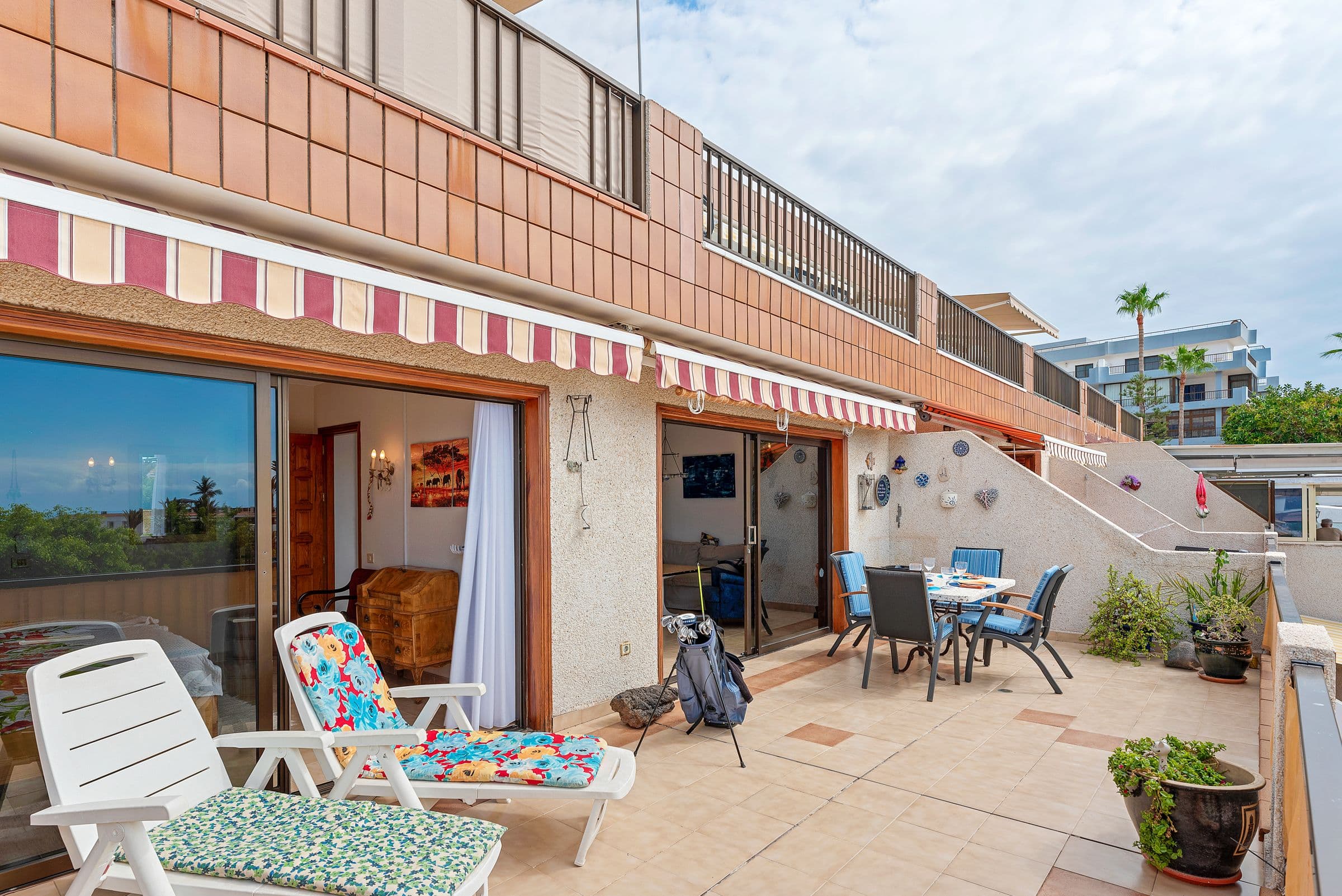 Terrace with sun loungers and awning